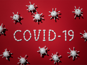 Schriftzug Covid-19 mit gezeichneten Viren
